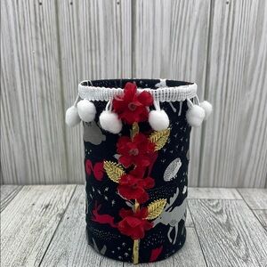 Decorative vase with floral details in black and red or pencil or object organiz